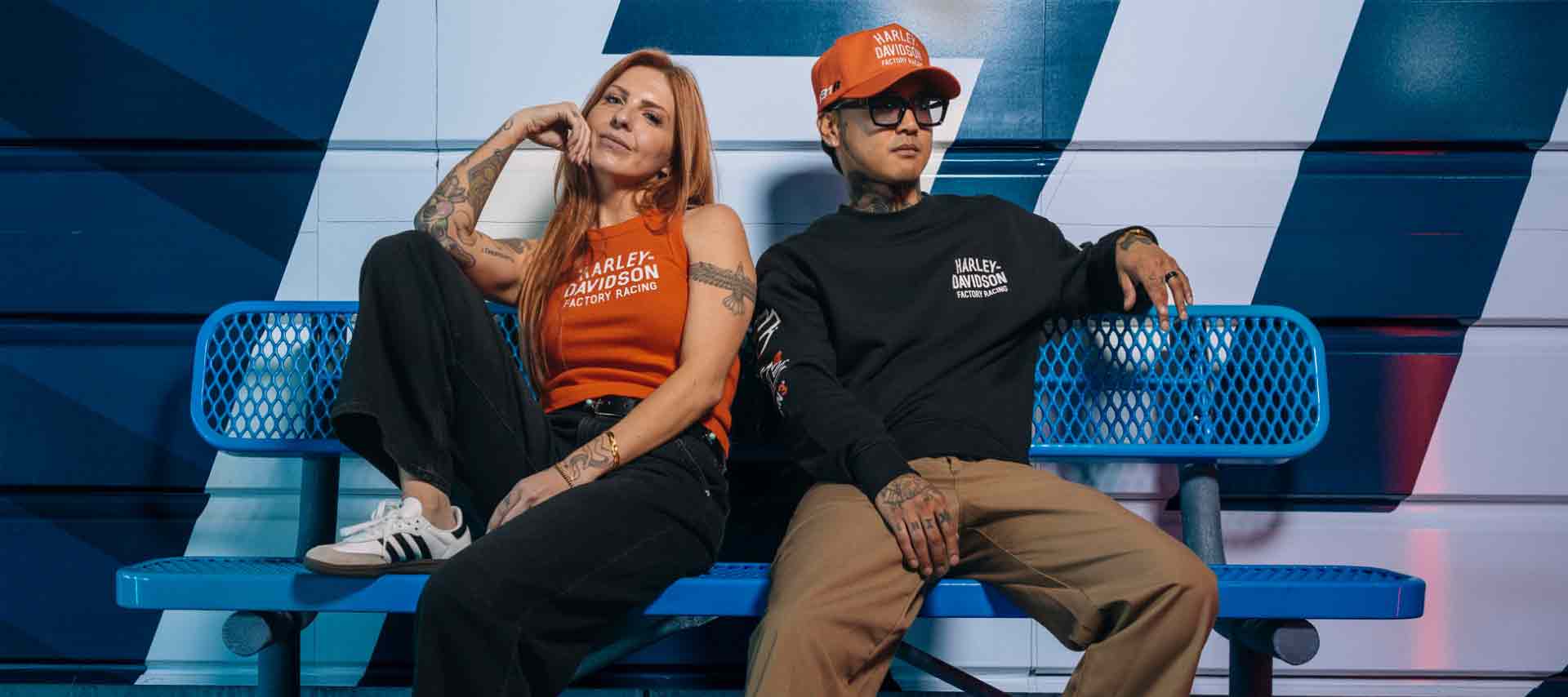 man and woman wearing factory racing clothing